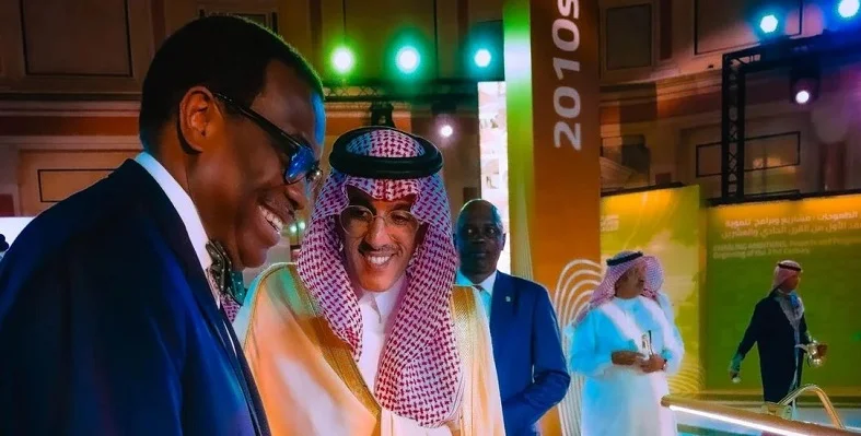 Akinwumi Adesina attending the event in Riyadh and smiling in conversation with a stakeholder.