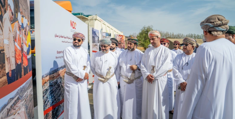 A group of Omani men dressed in traditional clothing at an outdoor event 