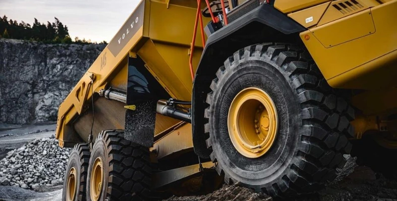 Image of a Volvo CE hauler near a construction site