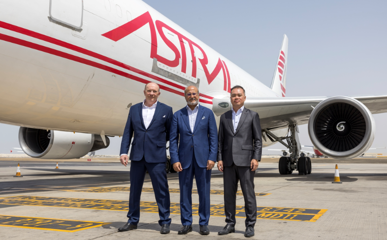 Key leaders from Astral Aviation and Etihad Cargo standing in front of an Astral aeroplane. 